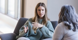Woman talking to another