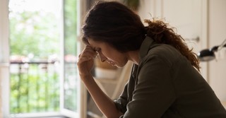A woman looking worried, sad
