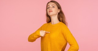 Woman pointing to herself