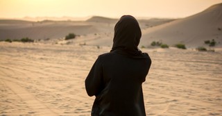 veiled woman in desert