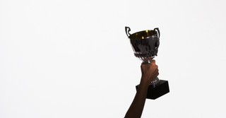 hand holding up trophy