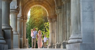 family standing together under columns