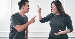Angry couple yelling and gesturing at each other