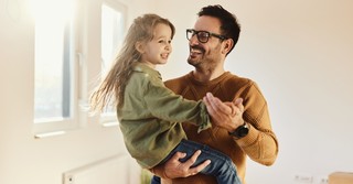 Father and young daughter dancing