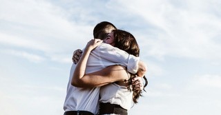 A man and a woman hugging in forgiveness