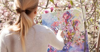 Woman painting flowers outside