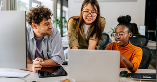 A team collaborating at work, smiling, and sharing ideas.
