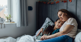 mother comforting sick child