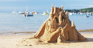 An elaborate sand castle on the beach