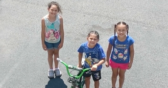 Children Raise Money One Cup at a Time to Buy Bikes for Their New Friends