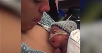 Newborn Smiles At Dad's Kisses