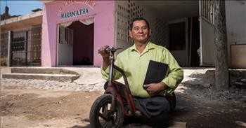 Man with Disabilities Pushes Scooter with His Hands to Share the Gospel