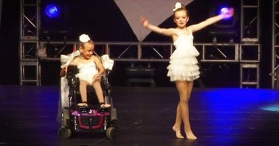 Older Sister Dances With Younger Sister In Wheelchair  