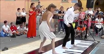 Couple Plays Floor Piano with Synchronized Dance 