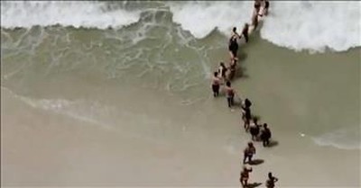 Beachgoers Form Human Chain To Save Swimmer Trapped In Raging Currents 