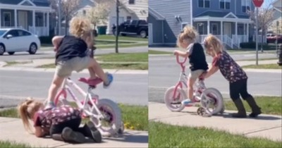 Big Sister Adorably Helps Little Sister Learn To Ride A Bike