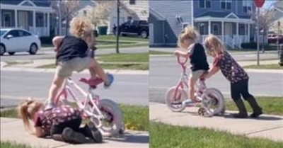 Big Sister Adorably Helps Little Sister Learn To Ride A Bike 