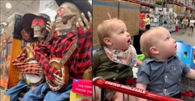 2 Babies In The Store Are Stunned By Music-Playing Halloween Decorations 