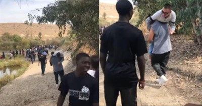 Students Carry Teacher When His Wheelchair Won’t Roll Through The Sand