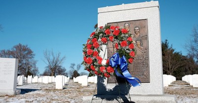 A wreath stands next to the NASA Challenger Memorial in winter
