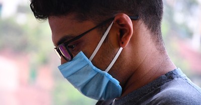 A man wearing a face mask, Do COVID vaccines present ethical concerns?