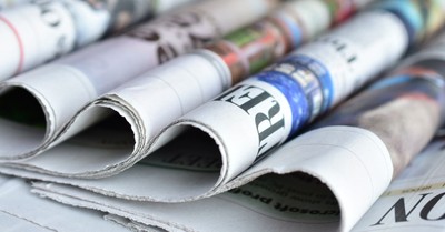 Folded newspapers in a row, top news pieces of 2021