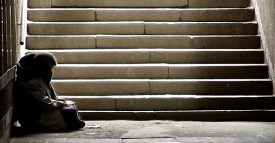 A homeless person sitting outside, A formerly homeless man praises God for turning his life around