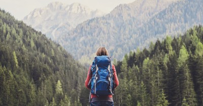 Woman with a backpack hiking in the mountains