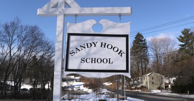 Sandy Hook school sign, Sandy hook survivor and victims' families settle with gun maker