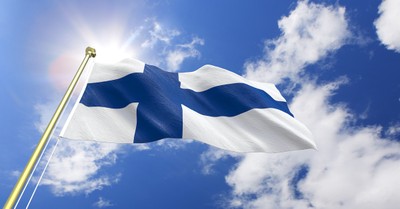 Flag of Finland waving in the blue sky