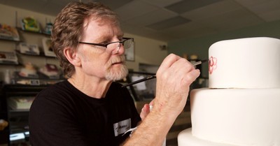 Jack Phillips painting on a cake, Court fines Masterpiece Cakeshop for declining to bake a gender transition cake