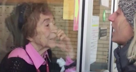 Woman Sings 'My Favorite Things' To Elderly Grandmother Through Glass Window