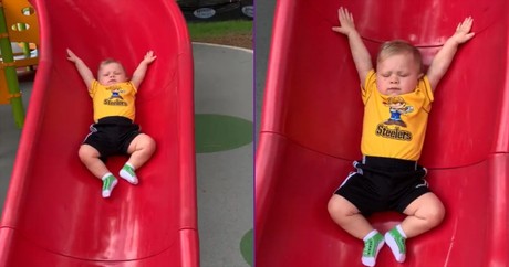 Little Guy Goes Down The Slide In Slow Motion