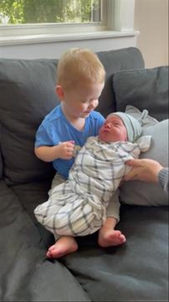 Boy Holds Little Brother for the First Time