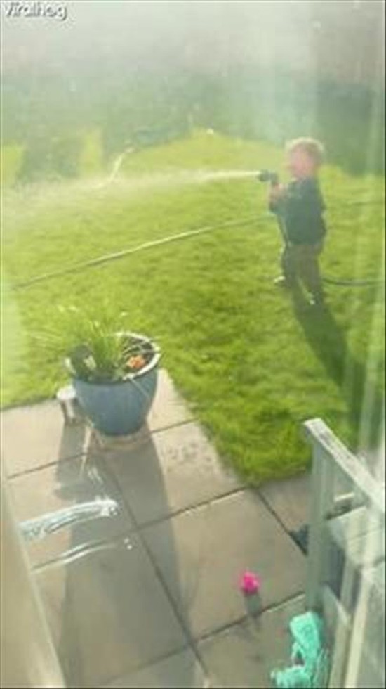 Toddler ‘Watering’ Grandad With the Hose