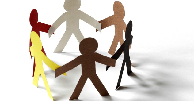 cutout paper people of all skin colors joining hands in a circle racial reconciliation