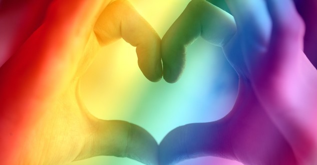 hands forming heart cast in rainbow lights gay marriage