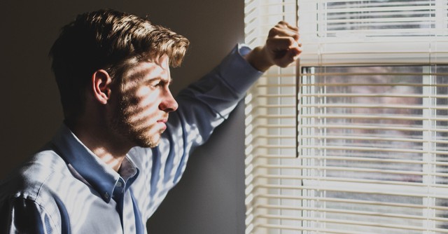 Man looking out the window