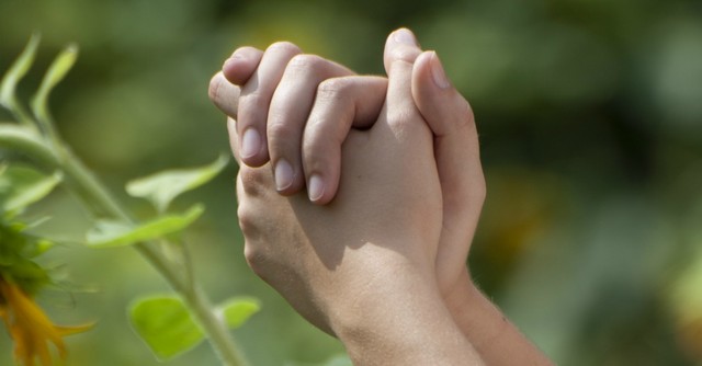 Close up of hands folded in prayer