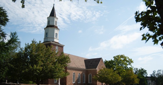 A brick church against a blue sky