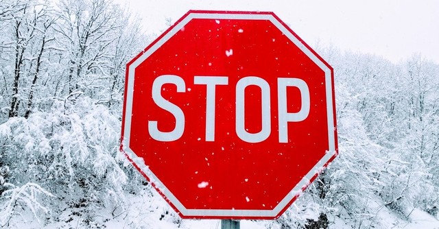 Stop sign in the snow, pride comes before the fall