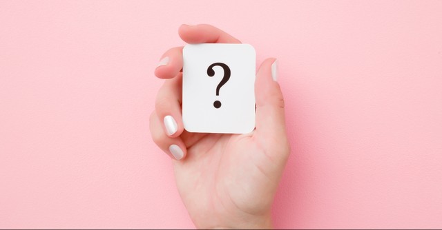 Hand holding a question mark card