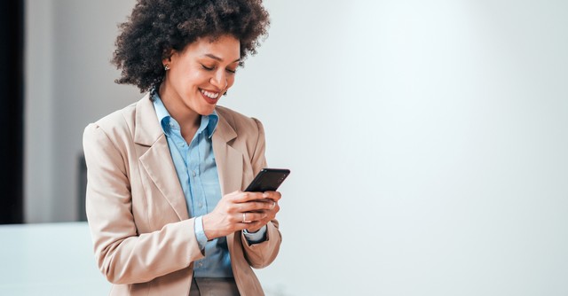 woman smiling at social media on her phone