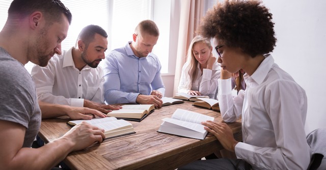 A group of adults reading their Bibles together