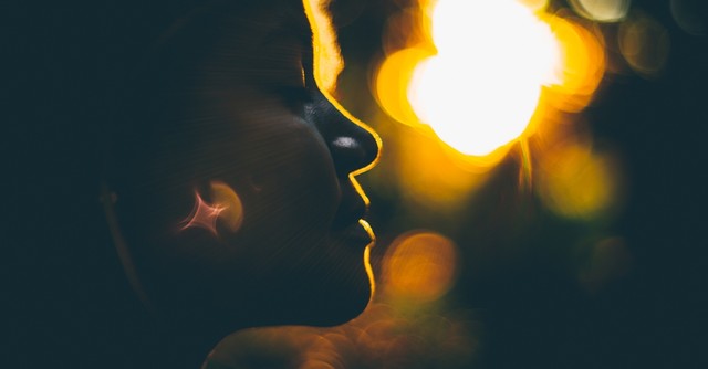 close up of woman's face eyes closed looking peaceful