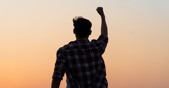 man with fist pump in air in victory