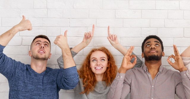 diverse adults looking and pointing up in hope that God answers prayer