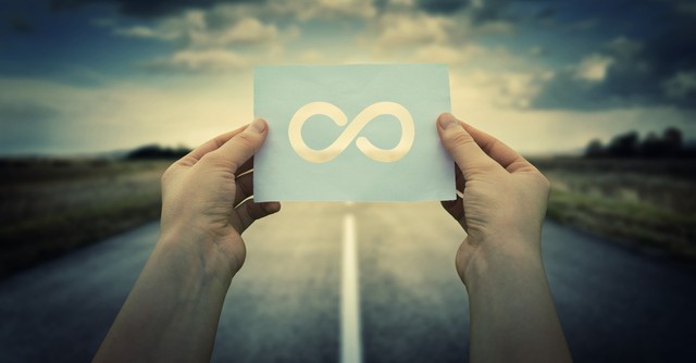 Man holding up an infinity symbol