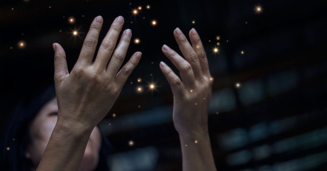 Woman holding her hands up in Disbelief with sparks, what the antichrist will look like
