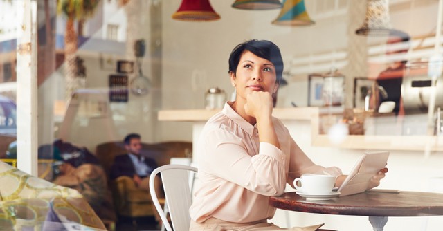 Woman thinking in coffee shop